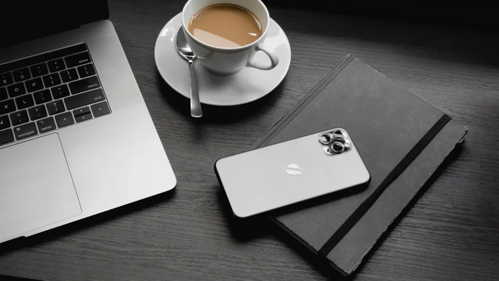 Laptop, smartphone and coffee on a desk