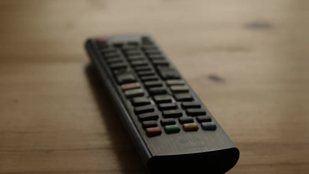 TV remote control on a wooden surface